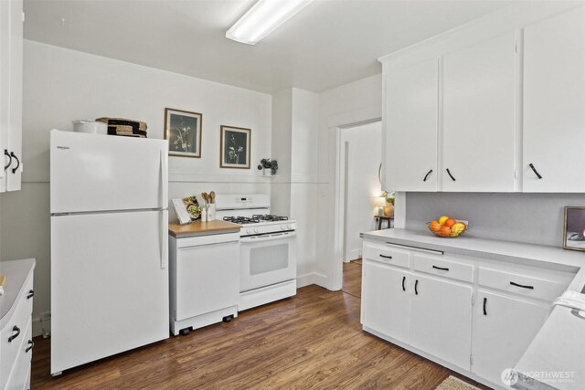 kitchen featuring white appliances, light countertops, white cabinetry, and dark wood-type flooring