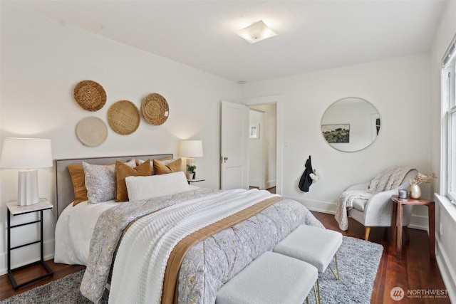 bedroom with wood finished floors and baseboards