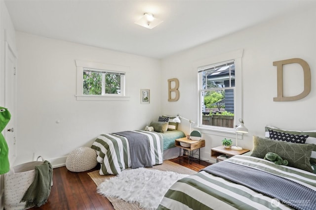 bedroom featuring hardwood / wood-style flooring and baseboards