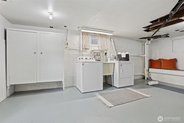 laundry area with washer and dryer and a sink
