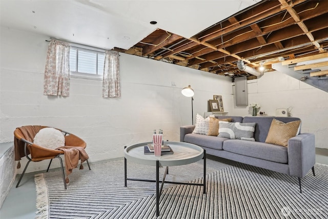 living area featuring electric panel and concrete flooring