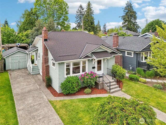 bungalow featuring a chimney, an outdoor structure, a front lawn, and concrete driveway