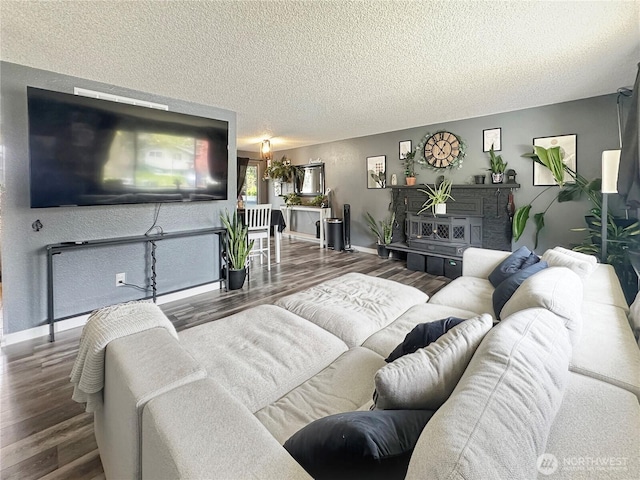 14914 20th Ave E, Parkland, WA 98445 - living room featuring a textured ceiling, wood finished floors, and baseboards