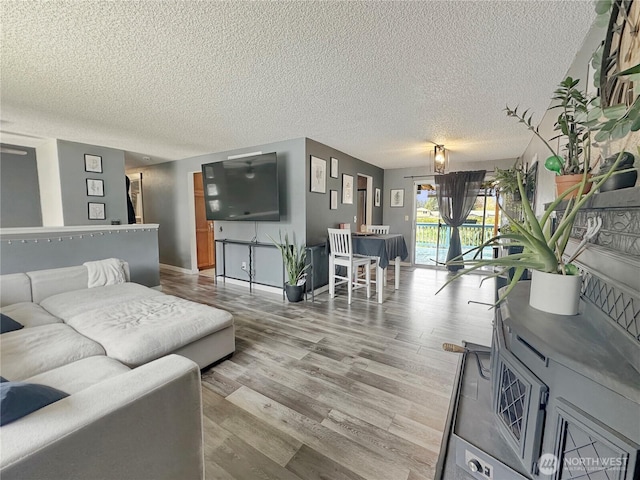 14914 20th Ave E, Parkland, WA 98445 - living room featuring baseboards, a textured ceiling, and wood finished floors
