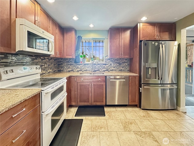 14914 20th Ave E, Parkland, WA 98445 - kitchen featuring a sink, tasteful backsplash, recessed lighting, light stone countertops, and appliances with stainless steel finishes
