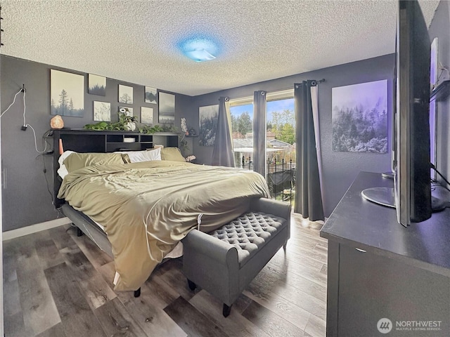 14914 20th Ave E, Parkland, WA 98445 - bedroom with a textured ceiling, access to outside, and wood finished floors