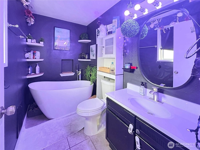 14914 20th Ave E, Parkland, WA 98445 - bathroom with toilet, tile patterned floors, a soaking tub, and vanity