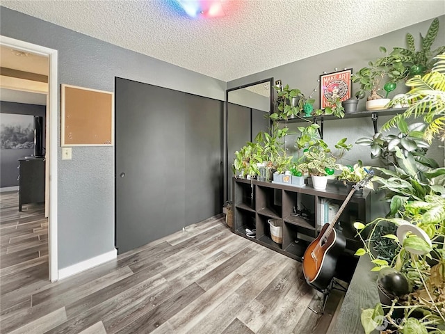 14914 20th Ave E, Parkland, WA 98445 - interior space featuring a textured ceiling, a textured wall, and wood finished floors