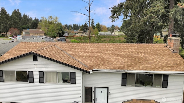 14914 20th Ave E, Parkland, WA 98445 - view of front facade featuring roof with shingles and a chimney