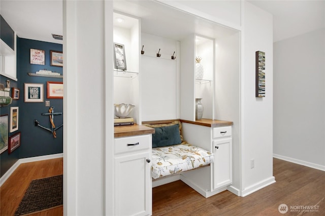 mudroom featuring baseboards and wood finished floors