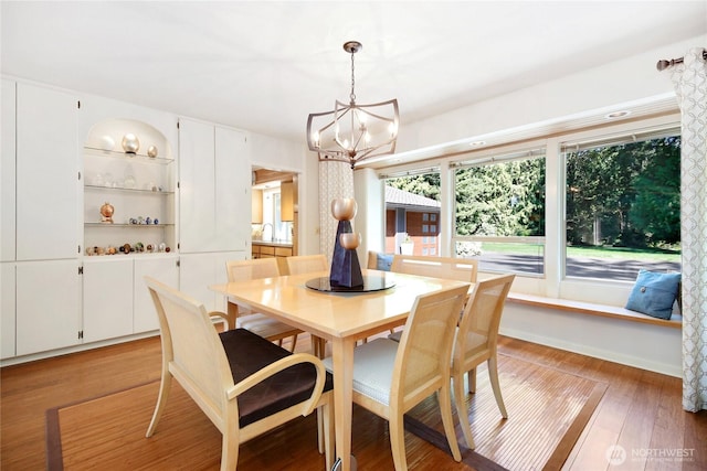 dining room featuring light wood-type flooring and a chandelier