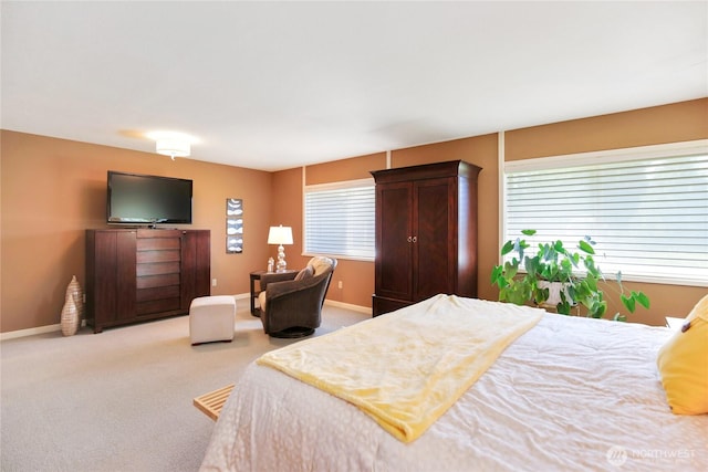 bedroom with light carpet and baseboards