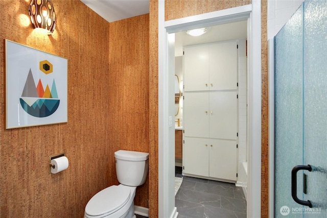 full bath with a shower with shower door, marble finish floor, and toilet