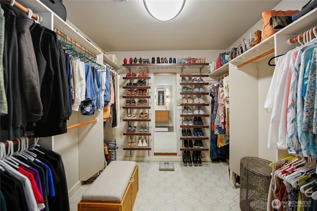 walk in closet with tile patterned floors