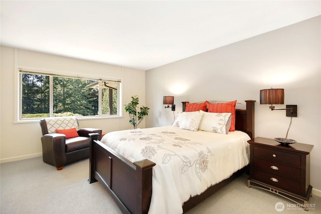 bedroom with baseboards and light colored carpet