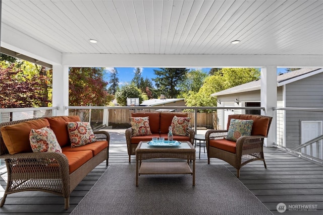 wooden terrace with an outdoor living space