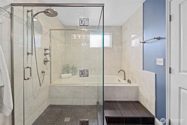 full bath featuring a garden tub and a shower stall