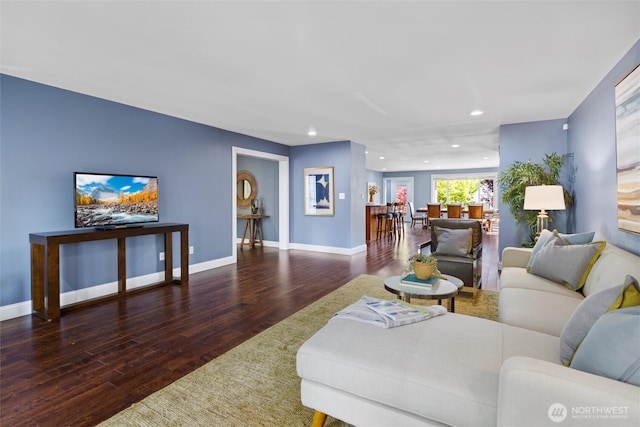 living room with baseboards, wood finished floors, and recessed lighting