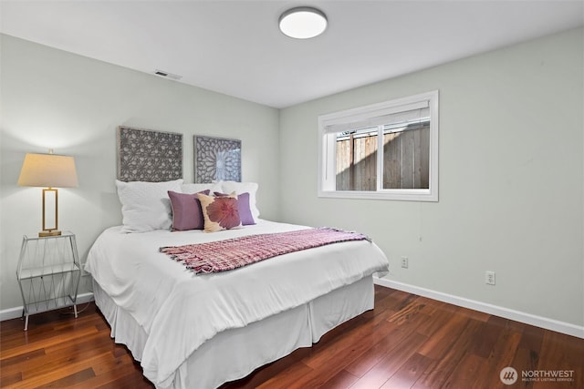 bedroom with hardwood / wood-style floors, baseboards, and visible vents