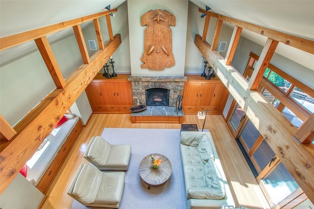 72 Thunderbird Trl, Orcas Island, WA 98280 - living area with wood finished floors, a stone fireplace, and a wainscoted wall