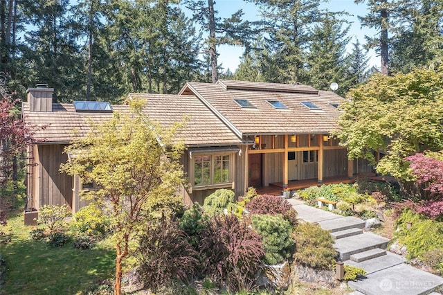 72 Thunderbird Trl, Orcas Island, WA 98280 - view of front of home featuring a chimney, board and batten siding, and a tile roof