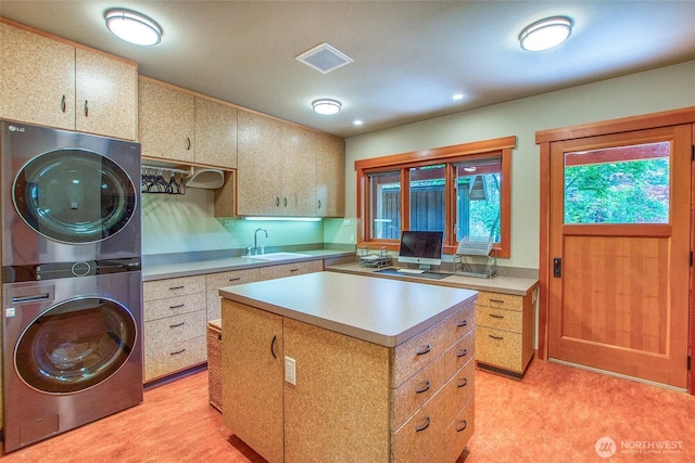 72 Thunderbird Trl, Orcas Island, WA 98280 - kitchen featuring stacked washer / drying machine, light countertops, a center island, a sink, and recessed lighting