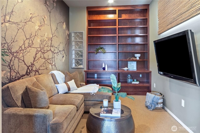 carpeted living area with baseboards and built in shelves