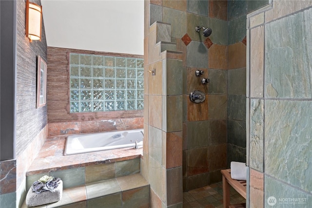 full bathroom with a walk in shower, tile walls, and a bath