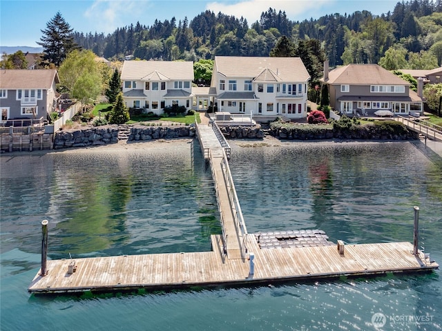 view of dock with a water view and a residential view