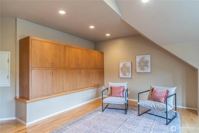 sitting room with recessed lighting, baseboards, light wood-type flooring, and lofted ceiling