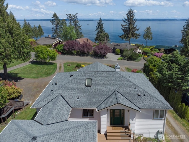 aerial view of property and surrounding area with a large body of water