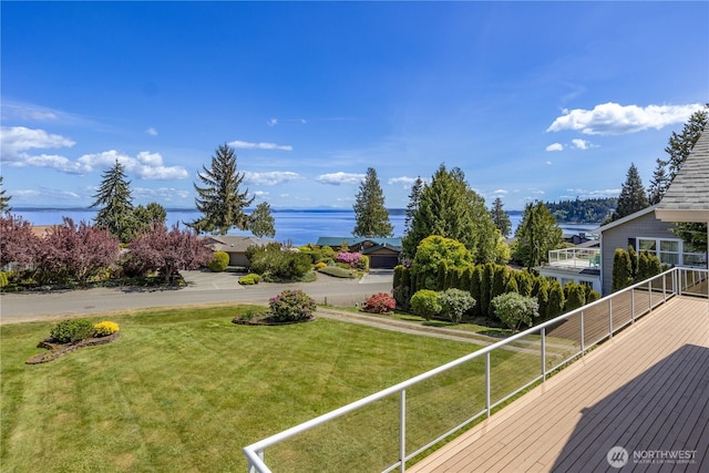 wooden deck featuring a lawn and a water view