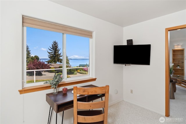 dining space featuring baseboards and speckle patterned floor