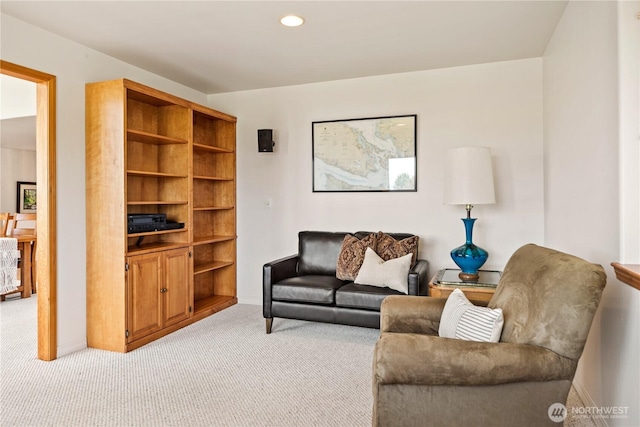 living area with light colored carpet and recessed lighting