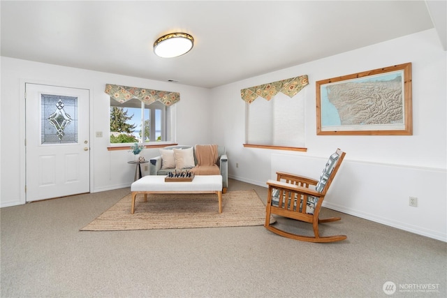 sitting room featuring carpet floors and baseboards