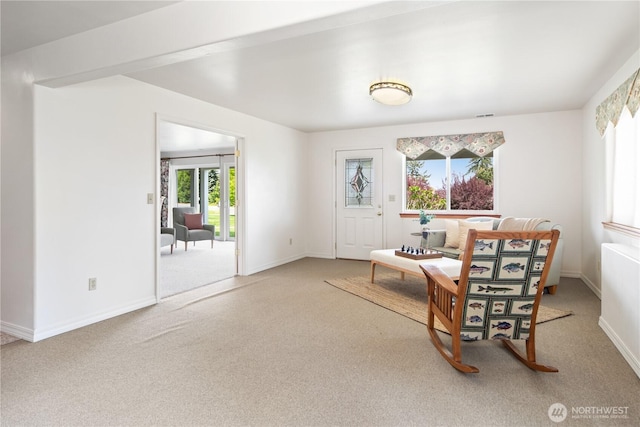 sitting room featuring carpet flooring and baseboards