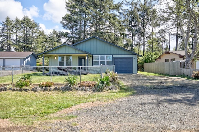 554 Puffin Ave NE, Ocean Shores, WA 98569 - view of front facade featuring an attached garage, fence, a front yard, and gravel driveway