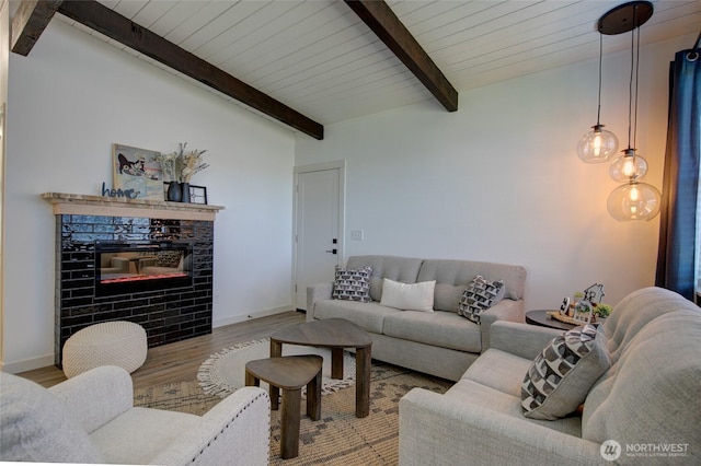 554 Puffin Ave NE, Ocean Shores, WA 98569 - living room with wood ceiling, wood finished floors, a fireplace, lofted ceiling with beams, and baseboards