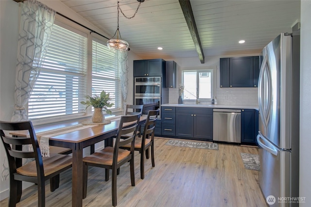 554 Puffin Ave NE, Ocean Shores, WA 98569 - dining room featuring wooden ceiling, light wood finished floors, beamed ceiling, and recessed lighting