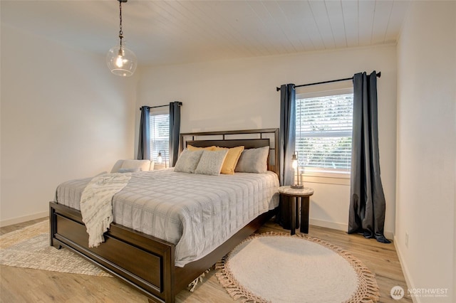 554 Puffin Ave NE, Ocean Shores, WA 98569 - bedroom with baseboards, multiple windows, and light wood finished floors