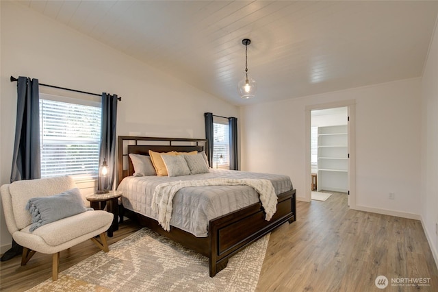 554 Puffin Ave NE, Ocean Shores, WA 98569 - bedroom with baseboards, light wood-style flooring, and vaulted ceiling