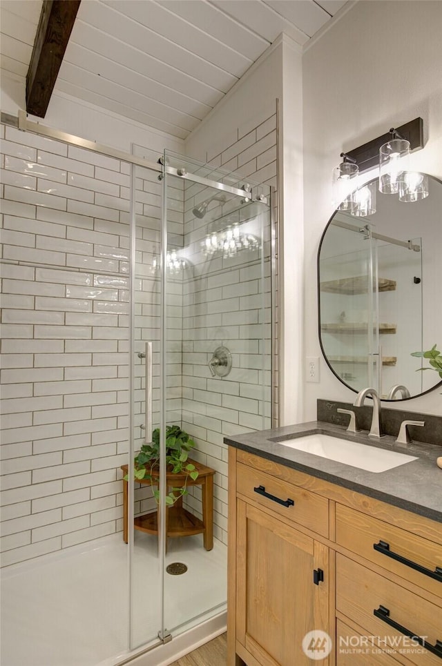 554 Puffin Ave NE, Ocean Shores, WA 98569 - full bath featuring a stall shower, vanity, and beam ceiling