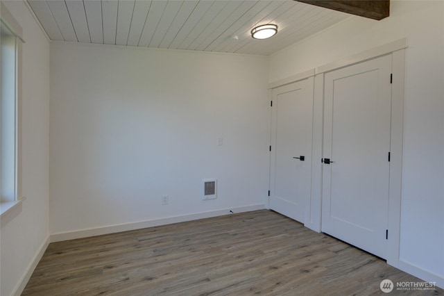 554 Puffin Ave NE, Ocean Shores, WA 98569 - unfurnished bedroom with a closet, wooden ceiling, visible vents, and wood finished floors