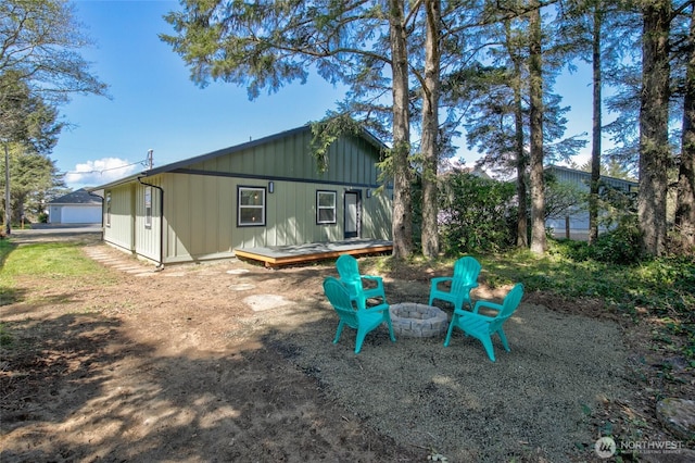 554 Puffin Ave NE, Ocean Shores, WA 98569 - back of property featuring an outdoor fire pit, board and batten siding, and a deck