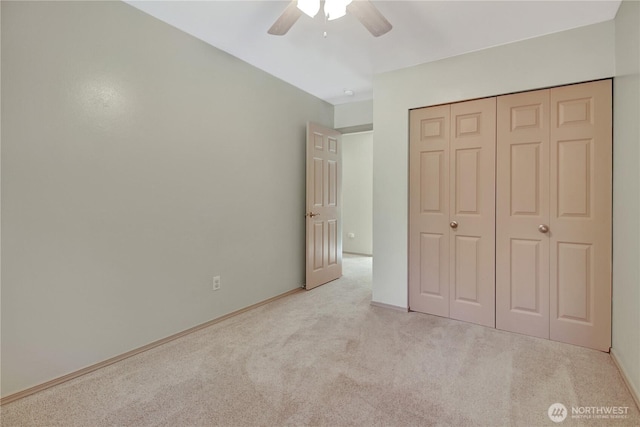 unfurnished bedroom featuring ceiling fan, a closet, and carpet