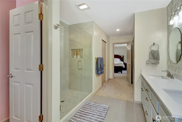 ensuite bathroom featuring a sink, ensuite bathroom, visible vents, tile patterned flooring, and a shower stall