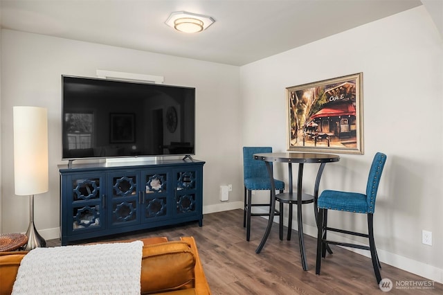 dining area featuring baseboards and wood finished floors
