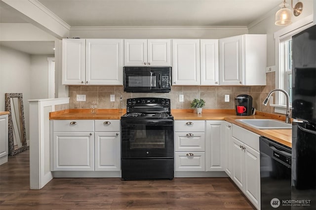 kitchen with a sink, tasteful backsplash, black appliances, and white cabinetry