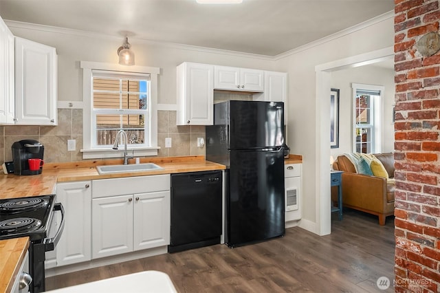 kitchen featuring dark wood finished floors, butcher block counters, a sink, and black appliances