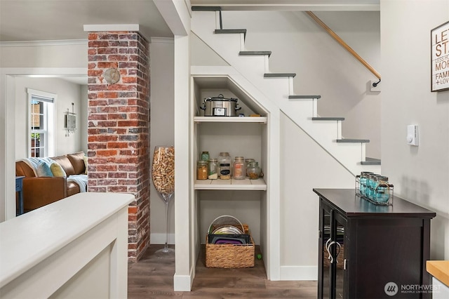 interior space featuring baseboards and wood finished floors